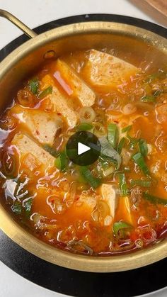 a pot filled with soup sitting on top of a stove