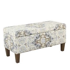 an upholstered bench with wooden legs and a floral pattern on the seat cover