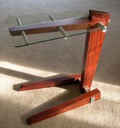 a glass and wood table on carpeted floor