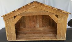 a dog house made out of wooden planks