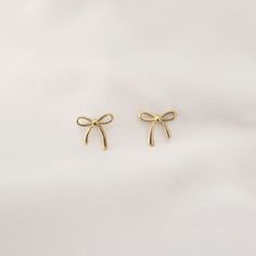 Dainty Ribbon Stud Earrings   - This listing is for pair os the Dainty Ribbon Stud Earring. Perfect for everyday and layering - Base Material: High Quality Stainless Steel - Measurement: Length - 4mm, Width - 5mm - Finish: 18K Gold - Nickel Free and Tarnish Free - All our jewelry is packaged in gift ready boxes. If you would like multiple items from your order packaged separately please let us know! © 2024 Generation of Daughters Ribbon Earring, Coquette Gifts, Coquette Earrings, Dainty Coquette, School Earrings, Coquette Ribbon, Ribbon Earrings, Earrings Simple, Gold Stud Earrings