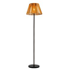 a floor lamp with a brown shade on it's side and a black base