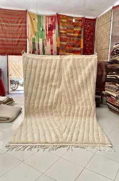 a room filled with lots of rugs and blankets