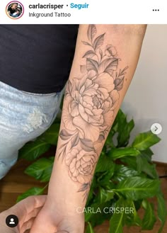 a woman's arm with a flower tattoo on the left side of her arm