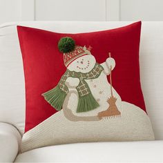 a red pillow with a snowman on it