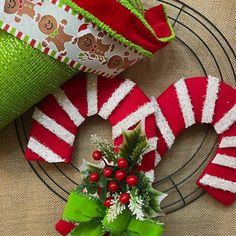 a christmas wreath sitting on top of a metal rack next to a green cloth bag