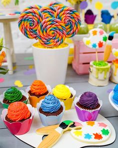 colorful cupcakes and candy are on the table