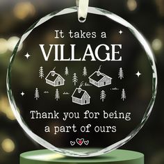 a glass ornament that says it takes a village thank you for being a part of ourss