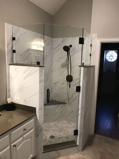 a walk in shower sitting inside of a bathroom