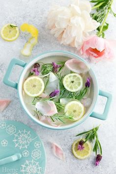 a bowl filled with lemon slices and flowers