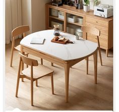 a table with two chairs and a book on it