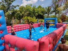 children playing in an inflatable water park