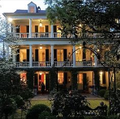 a large white house with lots of windows and balconies