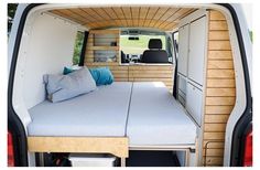 the back end of a van with a bed in it