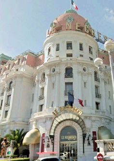 a large white building with a flag on top