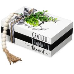 a white box with a black and white ribbon tied around it that reads grateful, thankful, blessed