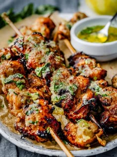 chicken kabobs on skewers with dipping sauce