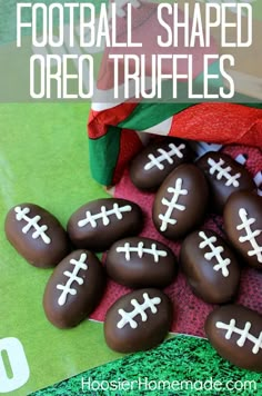 chocolate footballs with white crosses on them sitting next to a christmas ornament