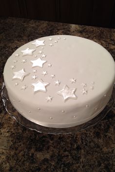 a large white cake with stars on it