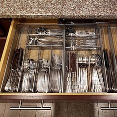 an open drawer filled with silverware and utensils