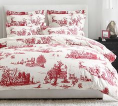 red and white bedding with trees on it