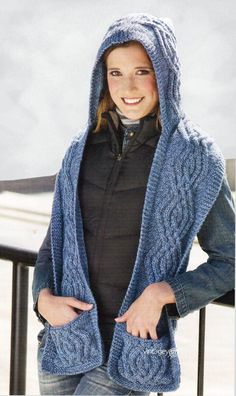 a woman wearing a blue knitted sweater and hood