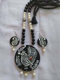 Handmade handpainted necklace with hanging earrings.  Beautiful painted on mdf sheet. Black glass beads n white pearl used in necklace. Navratri Set, Mdf Jewelry, Jewellery Making Tutorials Necklaces, Totebag Painting, Mdf Earrings, Painted Pendants, Diy Earrings Materials, Wooden Jewelery, Painted Necklace