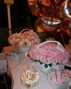 a table topped with lots of cakes and flowers