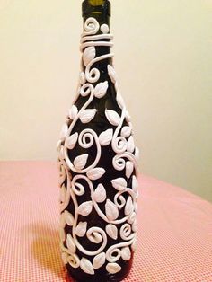 a black and white vase sitting on top of a pink table cloth covered tablecloth