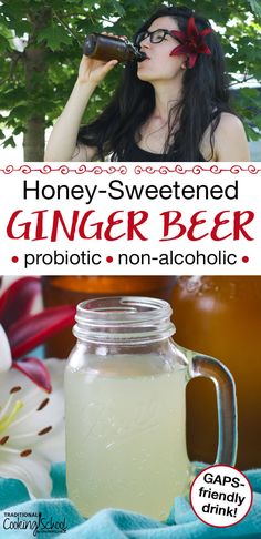 a woman drinking from a glass next to a jar of honey - sweetened ginger beer