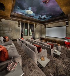 a home theater with couches, chairs and a projector screen in the center