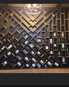 a wine rack with many bottles on it in front of a wall made out of shelves