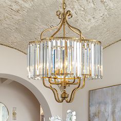 a chandelier hanging from the ceiling in a living room