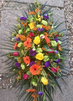 a bouquet of flowers sitting on top of a stone walkway