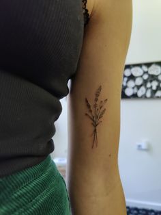 a woman with a small tattoo on her arm