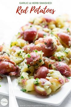 red potatoes with garlic and herbs on a white plate