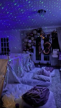 a bedroom decorated in purple and white with stars on the ceiling, bedding and decorations