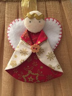 an angel ornament is hanging on a piece of burlocked fabric