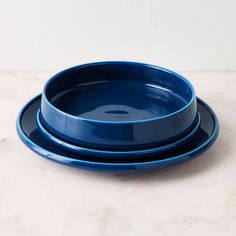 three blue plates stacked on top of each other