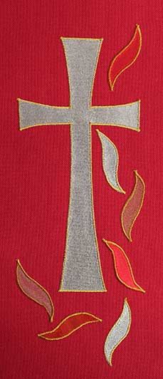 the cross is on top of a red t - shirt with flames coming out of it