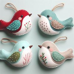 four felt bird ornaments hanging from twine