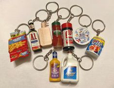 a bunch of food items that are on a keychain with some sort of bottle