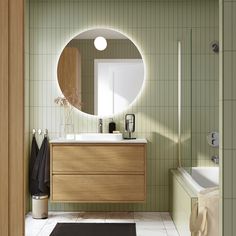 a bathroom with a sink, mirror and bathtub in the middle of the room