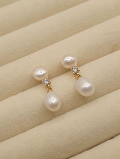 DESCRIPTION: These elegant freshwater pearl drop earrings feature delicate dangling pearls, perfect for adding a minimalist touch to any outfit. An ideal gift for mom or a timeless accessory for special occasions.  BEST FEATURES: Each earring is crafted with high-quality, natural pearls, ensuring unique beauty and luster. The simple yet elegant style makes these earrings versatile for everyday wear or special occasions. Designed for comfort, allowing for all-day wear without any discomfort or he Elegant Pearl Earrings, Elegant Pearl White Everyday Earrings, Dainty White Pearl Drop Earrings, Dainty Pearl Earrings, Cheap Pearl White Earrings With Pearl Charm, Delicate Pearl-embellished Earrings For Anniversary, Pearl White Dangle Earrings, Feminine Style, Elegant White Pearl Earrings, Tarnish Resistant, Large Pearl Earrings