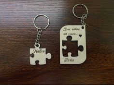 two personalized key chains with puzzle pieces on them