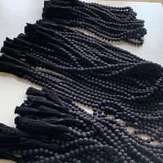 black beads are laid out on a table