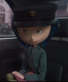 a doll sitting in the back seat of a car