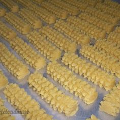 several rows of uncooked pasta sitting on top of a table