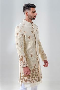 8449186167 Ceremonial Cream Bandhgala With Chikankari Embroidery, Ceremonial Beige Sherwani With Intricate Embroidery, Cream Sherwani With Naqshi In Raw Silk, Beige Sherwani With Intricate Embroidery For Ceremonial Occasions, Cream Embroidered Sherwani For Ceremonial Occasions, Beige Sherwani With Chikankari Embroidery For Reception, Cream Raw Silk Bandhgala For Reception, Designer Embroidered Cream Kurta, Beige Chikankari Embroidered Sherwani For Reception