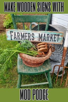 an old chair sitting in the grass next to a sign that says make wooden signs with farmers market moo poop